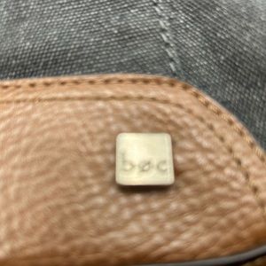 This is a large bag made by BOC. It is denim and tan leather.
